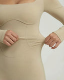 Woman wearing a long sleeve compression shorts sculpting romper designed for activewear and athleisure use.