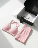 Model wearing a pink seamless sculpt gym set with high waist shorts and a supportive sports bra paired with athletic sneakers.