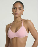 Model wearing a pink seamless sculpt gym set with high waist shorts and a supportive sports bra paired with athletic sneakers.