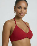 Model wearing a red seamless sculpt gym set with high waist shorts and a supportive sports bra paired with athletic sneakers.