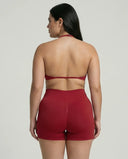 Model wearing a red seamless sculpt gym set with high waist shorts and a supportive sports bra paired with athletic sneakers.