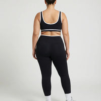 Woman wearing seamless sculpt activewear set with high waist leggings and supportive sports bra designed for gym, yoga, and athleisure wear.