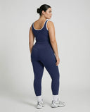 Woman wearing seamless sculpt high waist gym set with tank top and leggings in navy blue, shown from front and back.
