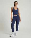 Woman wearing seamless sculpt high waist gym set with tank top and leggings in navy blue, shown from front and back.
