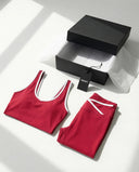 Woman wearing seamless sculpt high waist gym set with tank top and leggings in red, shown from front and back.