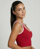 Woman wearing seamless sculpt high waist gym set with tank top and leggings in red, shown from front and back.