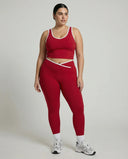 Woman wearing seamless sculpt high waist gym set with tank top and leggings in red, shown from front and back.