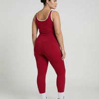 Woman wearing seamless sculpt high waist gym set with tank top and leggings in red, shown from front and back.