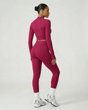 Woman wearing a seamless sculpting three piece activewear set with high waist leggings, sports bra, and fitted jacket paired with sneakers.