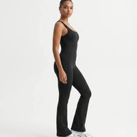 Plus size model front view wearing the black backless bodysuit, showing how the compression fit sits across curves.