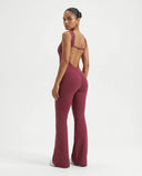 Back view of red backless bodysuit showing deep open-back design on a ghost mannequin.