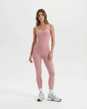 Ghost mannequin front view of pink backless full-length bodysuit showing scooped neckline and seamless waistline.