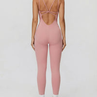 Ghost mannequin back view of pink backless bodysuit displaying open back detail and full-length leg.