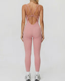 Ghost mannequin back view of pink backless bodysuit displaying open back detail and full-length leg.