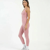 Plus size model front view wearing pink backless bodysuit in a studio setting showing inclusive fit.