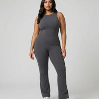 Model standing front-on in the ash backless flare bodysuit in a studio setting with arms relaxed at her sides.