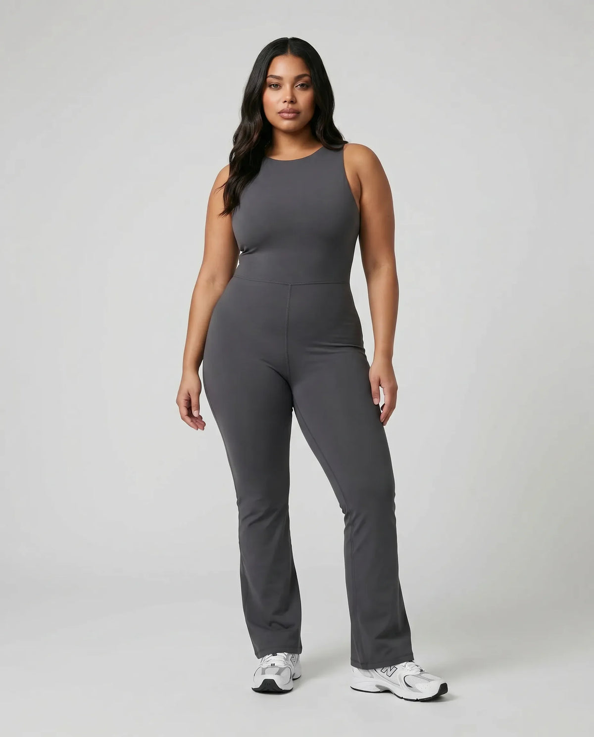 Model standing front-on in the ash backless flare bodysuit in a studio setting with arms relaxed at her sides.