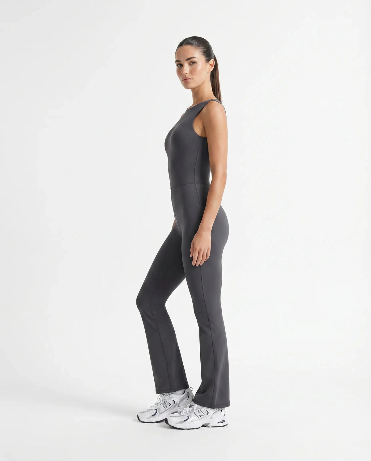Plus size model wearing the ash backless flare bodysuit from the front, showing the sculpting fit across the torso and hips.