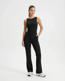 Front view of black backless flare bodysuit on ghost mannequin showing high neckline and flared legs.
