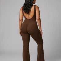 Model shown from behind wearing brown backless flare bodysuit, displaying the open back detail in studio lighting.