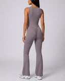Ghost mannequin back view of purple backless bodysuit highlighting the open back cutout and flared legs.