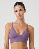 Ghost mannequin front view of purple sculpting seamless bra top and high waist legging set showing V-neckline and compression fit.
