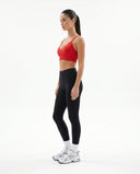 Plus size model back view showcasing the fit of the red seamless ribbed bra top across shoulders and back.