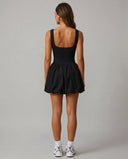 Back view of black balloon mini dress showing wide straps and gathered skirt on ghost mannequin.