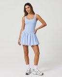 Ghost mannequin front view of light blue balloon hem activewear dress showing sculpting bodice and structured puff skirt.