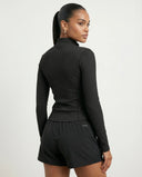 Back view of black zip-up compression jacket on ghost mannequin displaying clean seam lines and fitted silhouette.