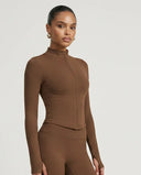 Front view of brown ribbed sculpting zip jacket on ghost mannequin showing full-length zip and mock neck detail.