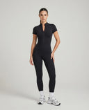 Ghost mannequin front view of brown short sleeve zip-front jumpsuit legging showing full-length silhouette and front zip detail.