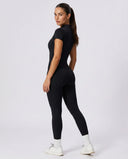 Ghost mannequin back view of brown short sleeve jumpsuit legging highlighting seamless back panel and ankle-length fit.