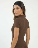 Ghost mannequin back view of black zip-front activewear jumpsuit displaying clean seam lines and ankle-length fit.