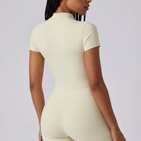 Ghost mannequin back view of yellow full-length activewear jumpsuit showing seamless back panel.