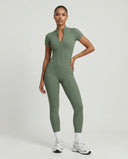 Front view of green ribbed half-zip jumpsuit on ghost mannequin showing zip detail and full-length silhouette.
