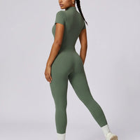 Back view of green ribbed half-zip jumpsuit on ghost mannequin displaying seamless back construction.