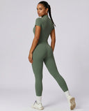 Back view of green ribbed half-zip jumpsuit on ghost mannequin displaying seamless back construction.
