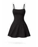 Women's black padel dress with spaghetti straps and side splits displayed on ghost mannequin front view.
