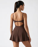 Women's brown padel dress with spaghetti straps and side splits displayed on ghost mannequin front view.
