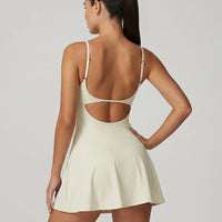 Women's padel dress in creme with square neckline and adjustable straps, ghost mannequin front view.
