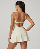 Women's padel dress in creme with square neckline and adjustable straps, ghost mannequin front view.
