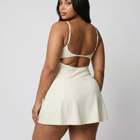 Women's padel dress in creme with square neckline and adjustable straps, ghost mannequin front view.
