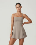 Women's grey padel dress with thin straps and A-line skirt displayed on ghost mannequin, front view.
