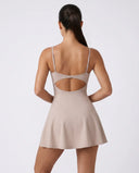Women's grey padel dress with thin straps and A-line skirt displayed on ghost mannequin, front view.
