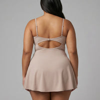 Women's grey padel dress with thin straps and A-line skirt displayed on ghost mannequin, front view.
