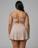 Women's grey padel dress with thin straps and A-line skirt displayed on ghost mannequin, front view.
