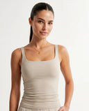 Front view of beige sculpting sleeveless tank top with square neckline on ghost mannequin.