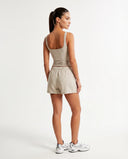 Back view of beige sleeveless tank top showing clean finish and thick straps on ghost mannequin.