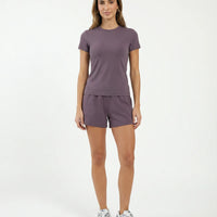 Ghost mannequin back view of purple fitted t-shirt top displaying clean back seam detail.